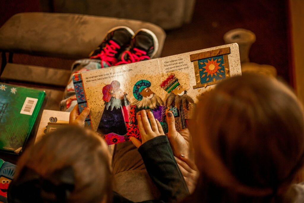 Two children reading a book together, representing imagination, life lessons and memorable moral stories