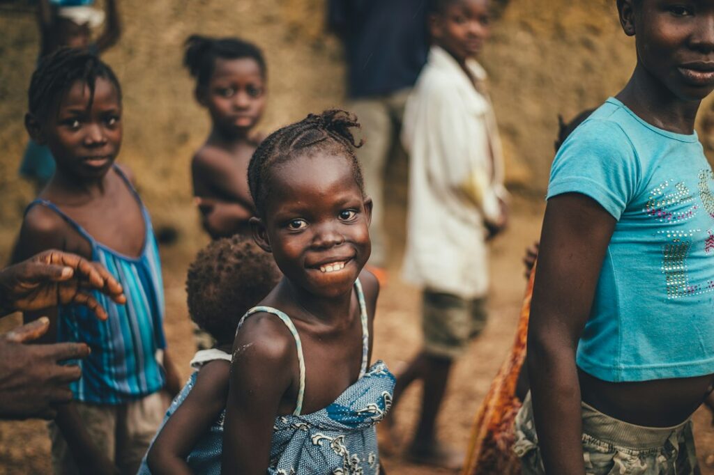 Children gathered in an African community setting, representing shared stories, community values and oral tradition