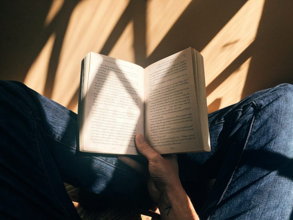 An adult reading quietly in warm light, representing reflection, moral choice and lifelong wisdom