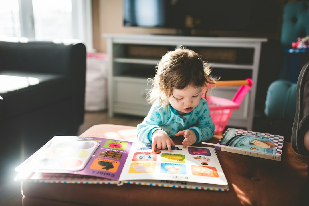 Child reading at home while choosing meaningful moral story books