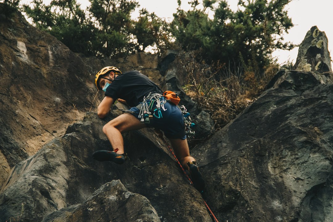 Person climbing a steep rock face
