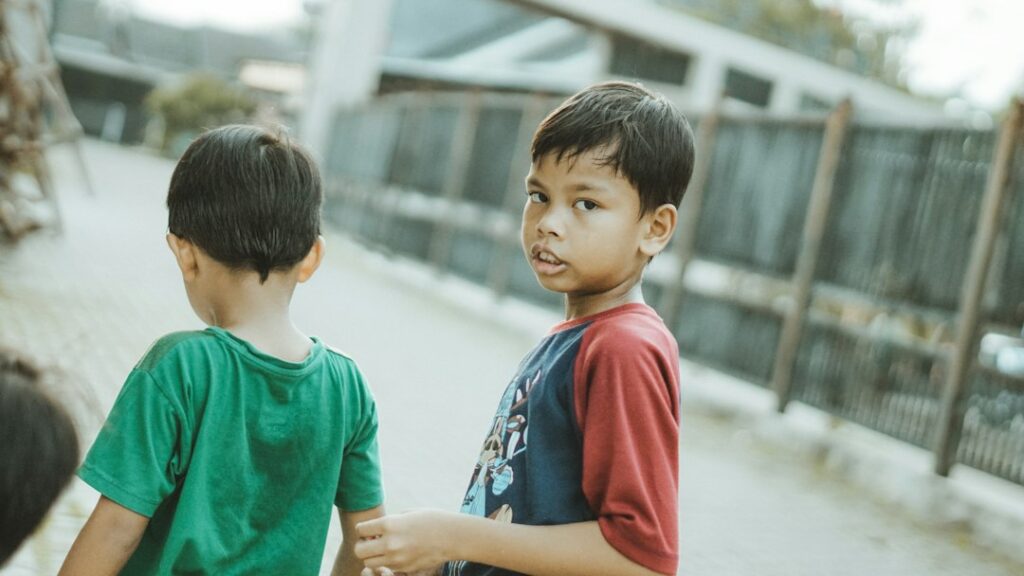 Two young friends walking together outdoors, representing trust, loyalty and friendship