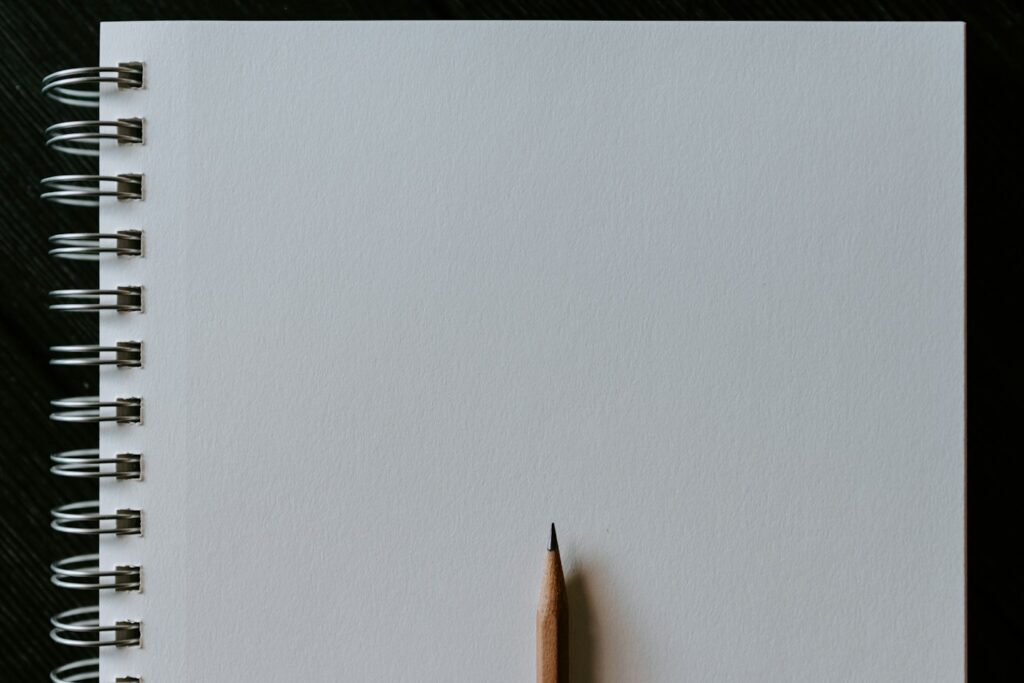 Blank notebook and pencil representing reading comprehension activities